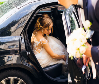 AdobeStock_194446941 Bride Getting Out of Car